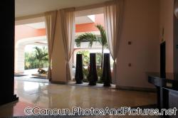 Three tall brown planters and ceiling high draps at Ocean Coral & Turquesa lobby.jpg