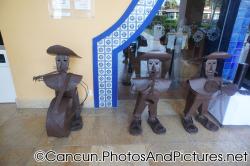 3 short brown sculptures outside of Mexican Restaurant of Ocean Coral & Turquesa.jpg