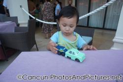 Darwin plays with cars whiile at outdoor table for Italian Restaurant of Ocean Coral & Turquesa.jpg