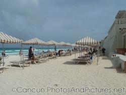 Beach chairs and canopy covers at beach of Crown Paradise resort next to GR Solaris.jpg