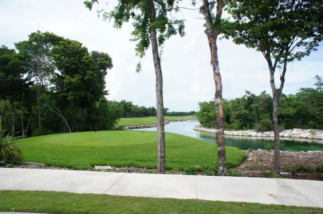 Grand Bahia Principe Sian Kaan Golf course hole next to pond.jpg