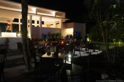 Outdoor tables outside of Gran Bahia Sian Kaan lobby at night.jpg