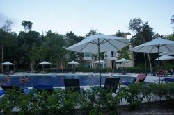 Pool and umbrellas and chairs and vacationers at Gran Bahia Principe Sian Kaan.jpg