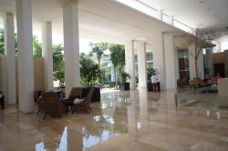 Shiny marble floors and chairs with tall white ceiling at Bahia Principe Sian Kaan lobby.jpg