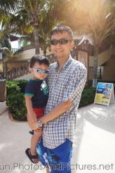 Darwin and Daddy in sunglasses at beach of GR Solaris resort in Cancun.jpg