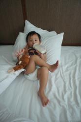 Darwin crosses legs and drinking milk in bed at Gran Bahia Principe Sian Kaan.jpg