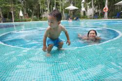 Darwin displays a surfing pose next to mommy at Gran Bahia Principe Sian Kaan pool.jpg