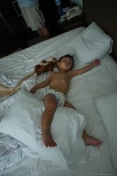 Darwin sleeping in Gran Bahia Principe Sian Kaan bed next to Monkey.jpg