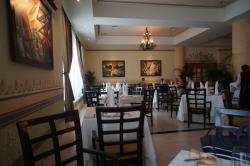 Tables and paintings inside Le Gourmet Gran Bahia Principe Akumal.jpg