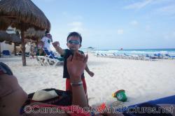 Darwin hands mommy a shell at the GR Solaris beach 2.jpg