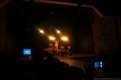 Performer handles a pole lit with fire in show at Performers on stage in cat costumes at Gran Bahia Principe Akumal theater.jpg