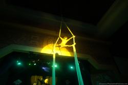 Performer in the air on white cloth ropes on stage at Gran Bahia Principe Akumal theater show.jpg