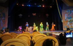 Performers in costumes hold a ball at Gran Bahia Principe Akumal theater.jpg