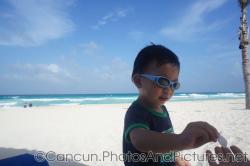 Darwin hands over a shell at GR Solaris beach.jpg