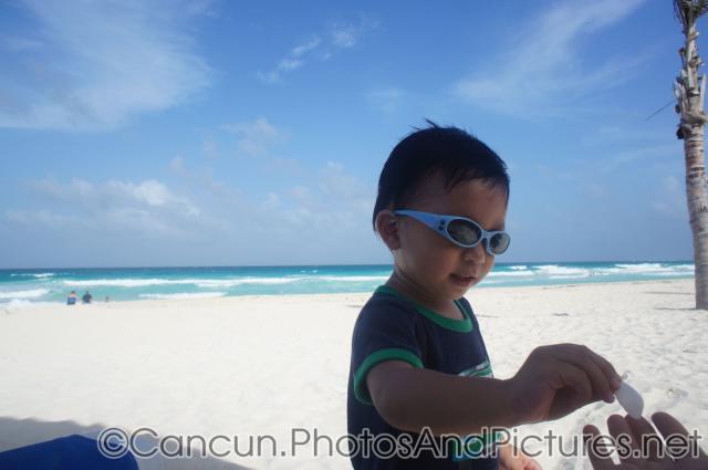 Darwin hands over a shell at GR Solaris beach.jpg