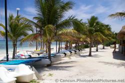 Rows of parked boats on beach sand at Grand Palladium Kantenah.jpg