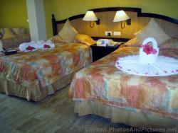 Beds inside a Royal Suites Yucatan Room at Grand Palladium Riviera Maya.jpg
