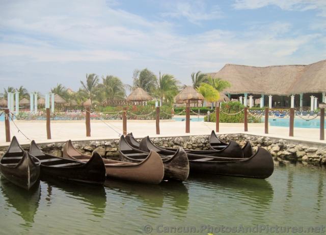 Canoes docked in lagoon near pool at Grand Palladium Riviera Maya.jpg