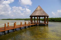 Pavillion with cone shape straw top at the Playa Mujeres lagoon.jpg