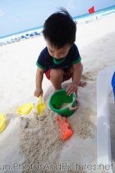 Darwin playing in the sand of beach at GR Solaris.jpg