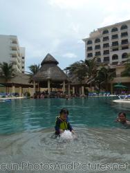 Darwin plays with water jet in pool at GR Solaris.jpg