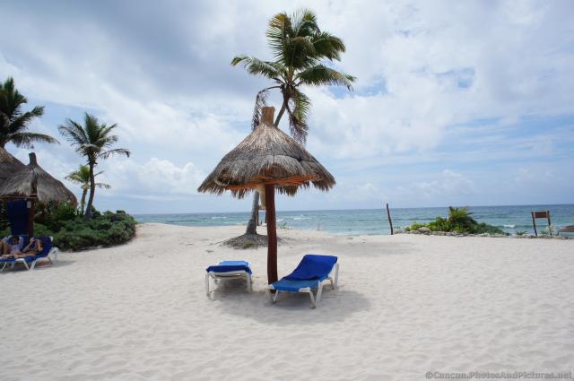 Umbrella and beach chairs at Grand Bahia Principe Tulum beach.jpg