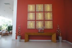 9 panel gold canvas wall decor and wooden table inside Gran Bahia Principe Sian Kaan Yal-Ku Restaurant.jpg