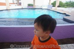 Darwin stands in front of the dolphin pool at the Cancun Interactive Aquarium.jpg