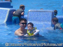 Darwin and daddy at the pool next to jets at Ocean Coral & Turquesa.jpg