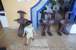 Darwin looks at brown metal sculptures of a band outside Mexican Restaurant of Ocean Coral & Turquesa.jpg