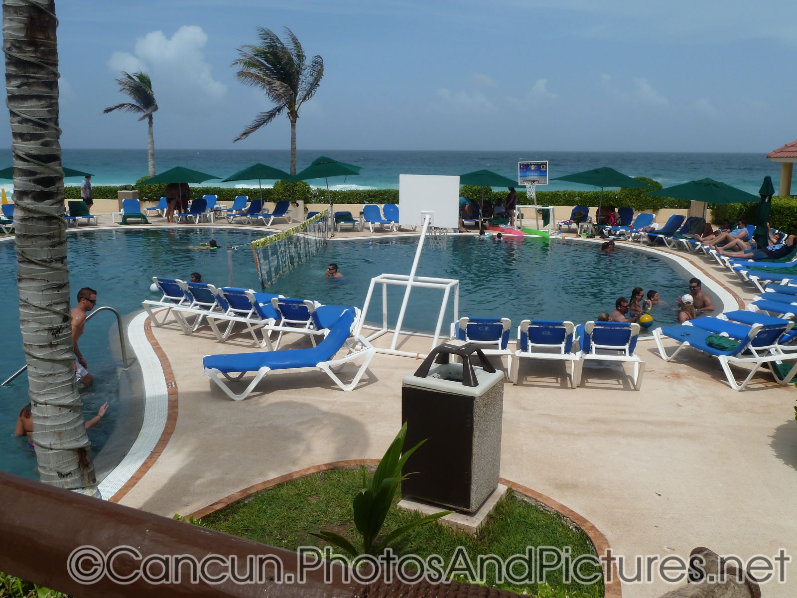 Pool bordering beach at GR Solaris.jpg