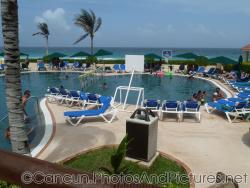 Pool bordering beach at GR Solaris.jpg